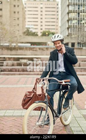 The world could do with more green. Portrait of a young businessman commuting to work with his bicycle. Stock Photo
