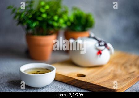 Close-up of an Asian tea set on a table with houseplants Stock Photo