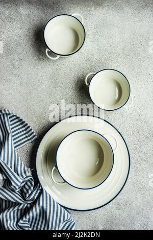 Overhead view of assorted bowls, plates and a tea towel Stock Photo