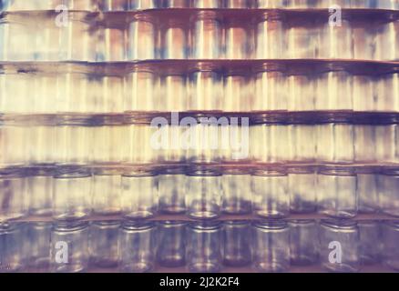 Blurred glass jars covered with plastic, abstract background. Stock Photo