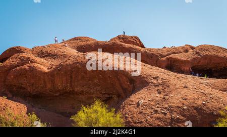 People climbing and visiting the rocks around Papago Park Hole in the Rock in Phoenix, Arizona, United States Stock Photo