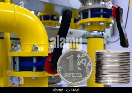 Gas burner and ruble coin, Russian money on home gas stove. Blue propane gas flame and ruble currency. Concept of Russia and Europe economy, natural g Stock Photo