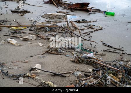 Close up of beach pollution. Garbage plastic, bottles, other unnecessary garbage from the tropical sea washed ashore. Selective focus. Ecological conc Stock Photo