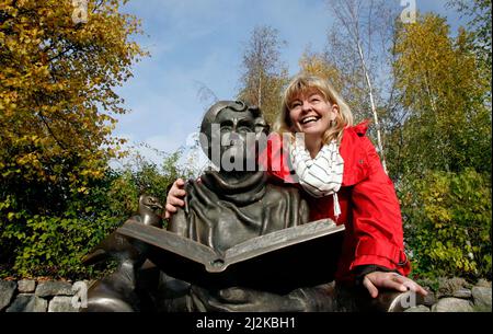 Portrait of the actress Inger Nilsson who played Astrid Lindgren's Pippi. Photographed at Djurgården in Stockholm. To the left the statue of Astrid Lindgren. Stock Photo