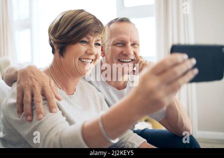 Your smile lights up my world. Shot of a mature couple taking selfies. Stock Photo