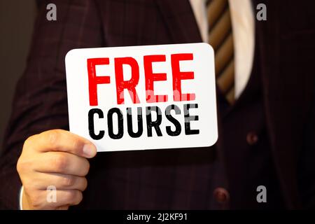 FREE ONLINE COURSE, message on the card shown by a man Stock Photo