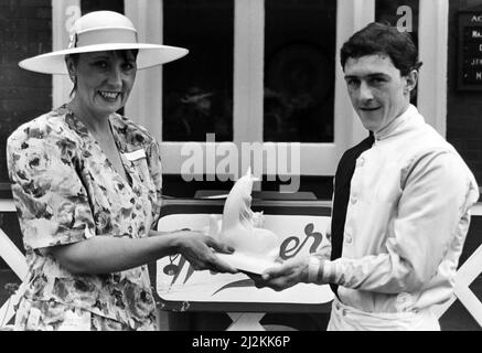 Redcar Racecourse is a thoroughbred horse racing venue located in Redcar, North Yorkshire. Mrs Ann Hill, wife of Gazette managing director Tony Hill, presents Gazette race winner, jockey Willie Ryan, with a Royal Doultan statue. 6th August 1988. Stock Photo