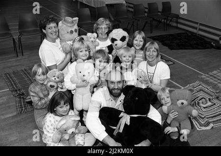 Taking their teddies for a picnic organised by Holmfirth and Meltham Lions are these youngsters with president Mr David Mosley. The event at Holmfirth Civic Hall raised around £600 for the BBC Children In Need Appeal. All the children who took a teddy bear to the picnic were given a free tea. Also featured were a story corner for younger children and a book stall run by The Children's Book Shop, Lindley – which gave a donation from its sales to the Children In Need Appeal. 22nd November 1987. Stock Photo