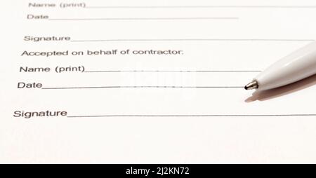 Top view on working place. Laptop and open notebook with pen on beige table. Notepad sheets on silver brackets, automatic ballpoint pen in silver-blac Stock Photo