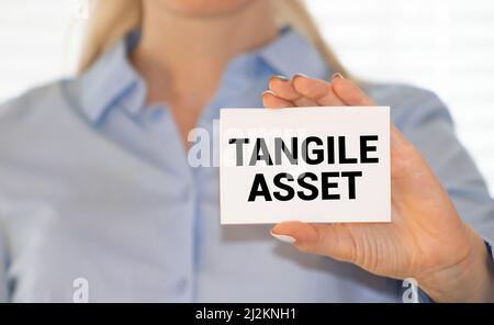 Tangible Asset text written on a notebook with pencils Stock Photo