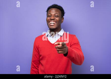 Laughing young african american man pointing index finger on camera. Great joke concept Stock Photo