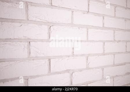 Textured white brick background. Decorative tiles for wall decoration. White decorative brick. Loft decor style. Structural surface that mimics brick. Stock Photo