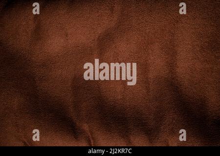 Background texture of dark brown fabric closeup. Brown canvas grunge background texture. Stock Photo