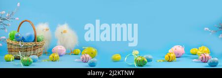 Easter chickens. Easter background. Happy Easter card. Multicolored eggs. Easter chickens on a blue background. Banner. copy space Stock Photo