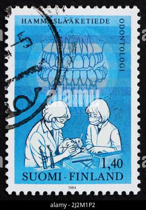 FINLAND - CIRCA 1984: a stamp printed in the Finland shows Dentist and teeth, Dentistry, circa 1984 Stock Photo