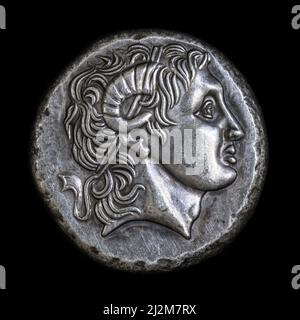 Alexander the Great head on Ancient Greek coin of Lysimachus, 290 BC. Silver tetradrachm, old rare money isolated on black, macro. Concept of Hellenis Stock Photo