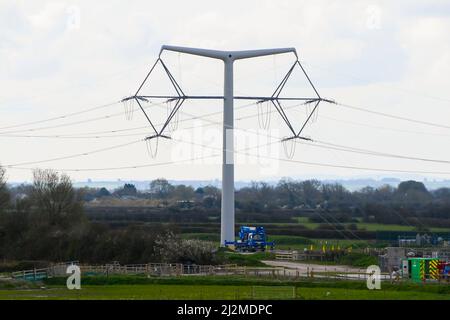 Loxton, Somerset, UK.  2nd April 2022.  General view of the new National Grid T-Pylons at Loxton in Somerset which have been built on the Somerset levels as part of the Hinkley Point C nuclear power station project.  Picture Credit: Graham Hunt/Alamy Live News Stock Photo