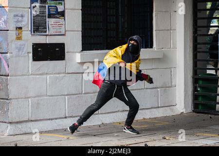 March 31, 2022, Bogota, Cundinamarca, Colombia: A demonstrator uses a Colombian flag while throwing rocks and debree as students protested against Colombia's national police and government on March 31, 2022 in Bogota, Colombia. As demonstrators and Colombia's riot police squad 'ESMAD' ended up in clashes in northern Bogota. Photo by: Daniel Romero/Long Visual Press (Credit Image: © Daniel Romero/LongVisual via ZUMA Press Wire)