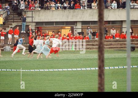 HRH The Princess of Wales, Princess Diana runs in her sons William and Harry's School Sports Day.  She is wearing the white top and long red skirt. The Princess came in 3rd.  In 1989 she came in 2nd and in 1988, she came in 1st.  None of her family this year won, with Charles coming in 12th out of 30 in the dads race, Harry not winning anything, and William taking a tumble in the novelty event.  Picture taken 12th June 1990 Stock Photo