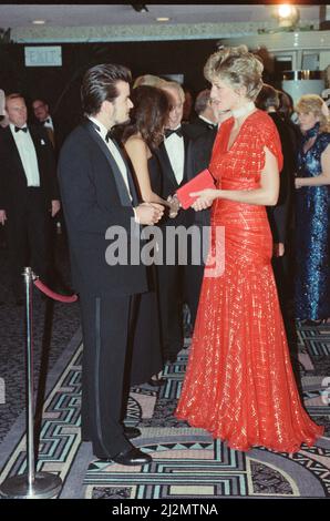 HRH The Princess of Wales, Princess Diana, attends the Odeon Leicester Square premiere of the film Hot Shots, starring Charlie Sheen. The Princess brought along a couple of uninvited guests, President Arpad  Goncz of Hungary, and his wife Szusza.  Diana wore a stunning red shot through with gold thread dress, and is pictured here meeting Charlie Sheen.  Picture taken 18th November 1991 Stock Photo