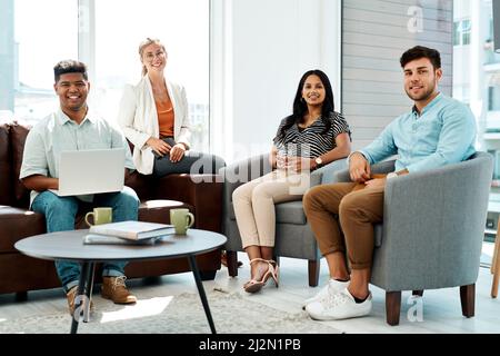 The team who know all about developing top ideas. Portrait of a group of businesspeople having a discussion in an office lounge. Stock Photo