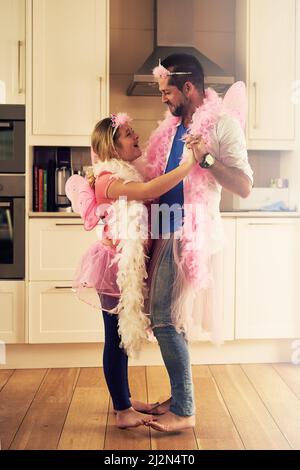 Practising for the royal princess ball. Shot of a father and his little daughter dancing together at home. Stock Photo