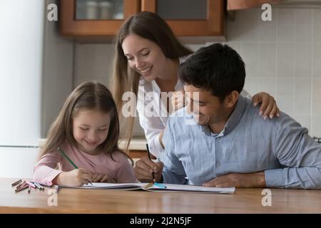 Happy parents and little daughter kid drawing colorful doodles Stock Photo