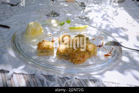 a baklava dessert with pistachio ice cream on the table of one of the best traditional cuisine restaurants in Sofia Stock Photo