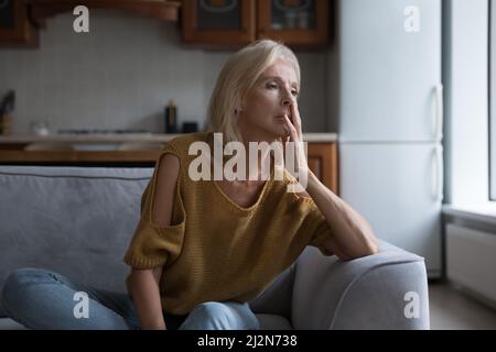 Frustrated lonely mature 50s woman looking away Stock Photo