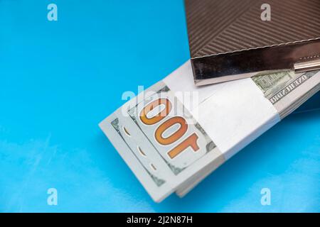 a bundle of us dollars in a metal box, indoor shallow dof shot Stock Photo