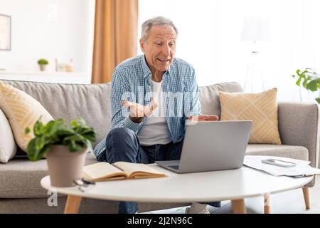 Mature man having video call using pc and talking Stock Photo