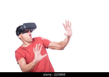 Amazed man in exploring virtual reality in VR glasses Stock Photo