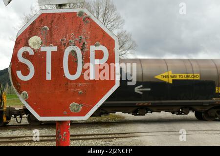 REEFTON, NEW ZEALAND, SEPTEMBER 6, 2021: A freight train passes a stop sign at Reefton  Railway Station, September 6,  2021. Stock Photo