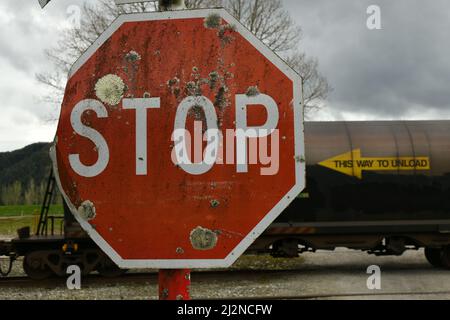 REEFTON, NEW ZEALAND, SEPTEMBER 6, 2021: A freight train passes a stop sign at Reefton  Railway Station, September 6,  2021. Stock Photo