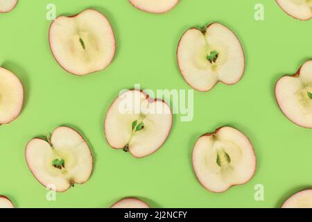 Top view of apple slices on green background Stock Photo
