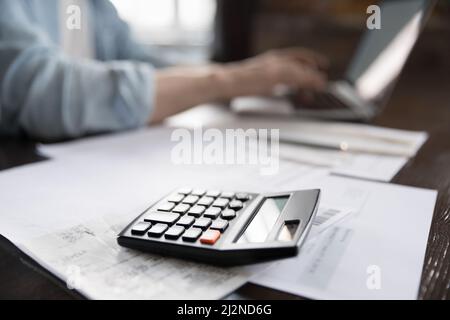 Accountant calculator and financial documents on work table Stock Photo