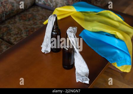 Molotov cocktail bottle on flag of ukraine background Stock Photo
