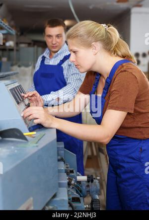 Young woman with male working in workshop Stock Photo
