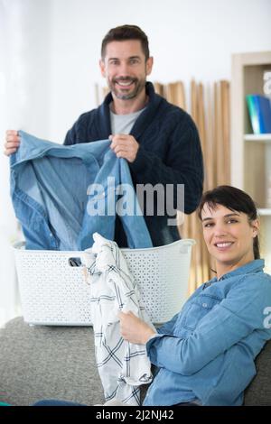 happy couple doing the laundry together Stock Photo