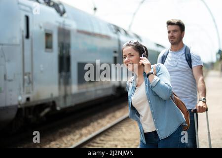 woman using smartphone at the train station Stock Photo