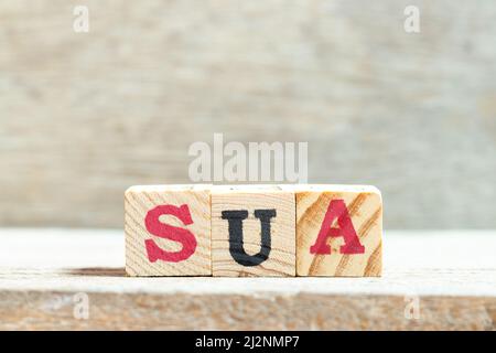 Alphabet letter block in word SUA (Abbreviation of Single use account) on wood background Stock Photo