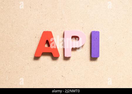 Color alphabet letter in word API (Abbreviation of Application programming interface or Active pharmaceutical ingredient) on wood background Stock Photo