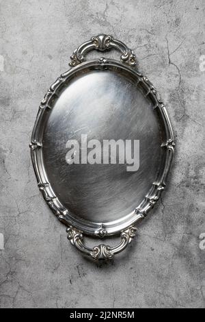 Empty silver vintage plate on gray background Stock Photo