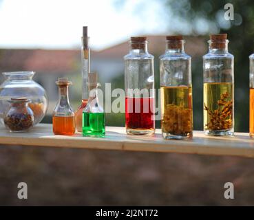 many galss small bottles with colored liquids that can be used as magical positions or elixir of long life in medieval times Stock Photo