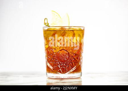Cocktail with cognac in a glass of old fashion on the bar. Stock Photo