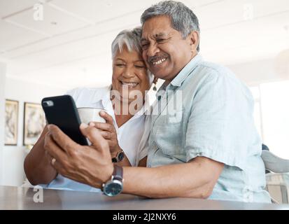 Its so nice seeing everyone. Shot of a senior couple on a call together at home. Stock Photo