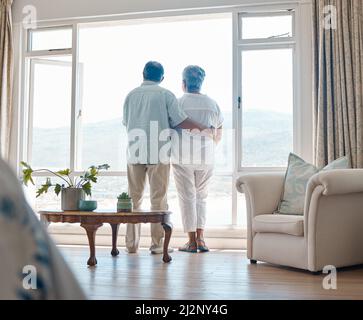 Enjoying some downtime. Rearview angle shot of a senior couple relaxing spending time together at home. Stock Photo