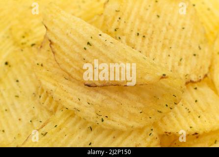 Corrugated potato chips close-up. Chips with additives and spices Stock Photo
