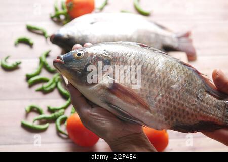 top view of raw fresh fish on hand  Stock Photo