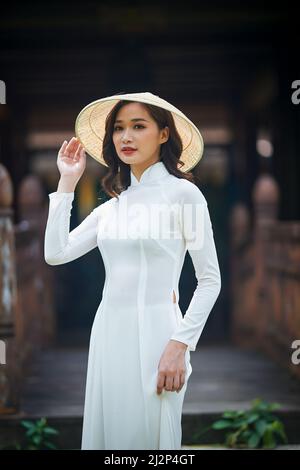 Ho Chi Minh City, Vietnam: Portrait women in white ao dai Vietnam, The Ao  dai ( long-dress Vietnamese) is traditional costume of Vietnamese woman  Stock Photo - Alamy